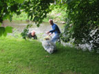 Pittsfield City Councilor Matt Kerwood and another volunteer cleaning the river bank